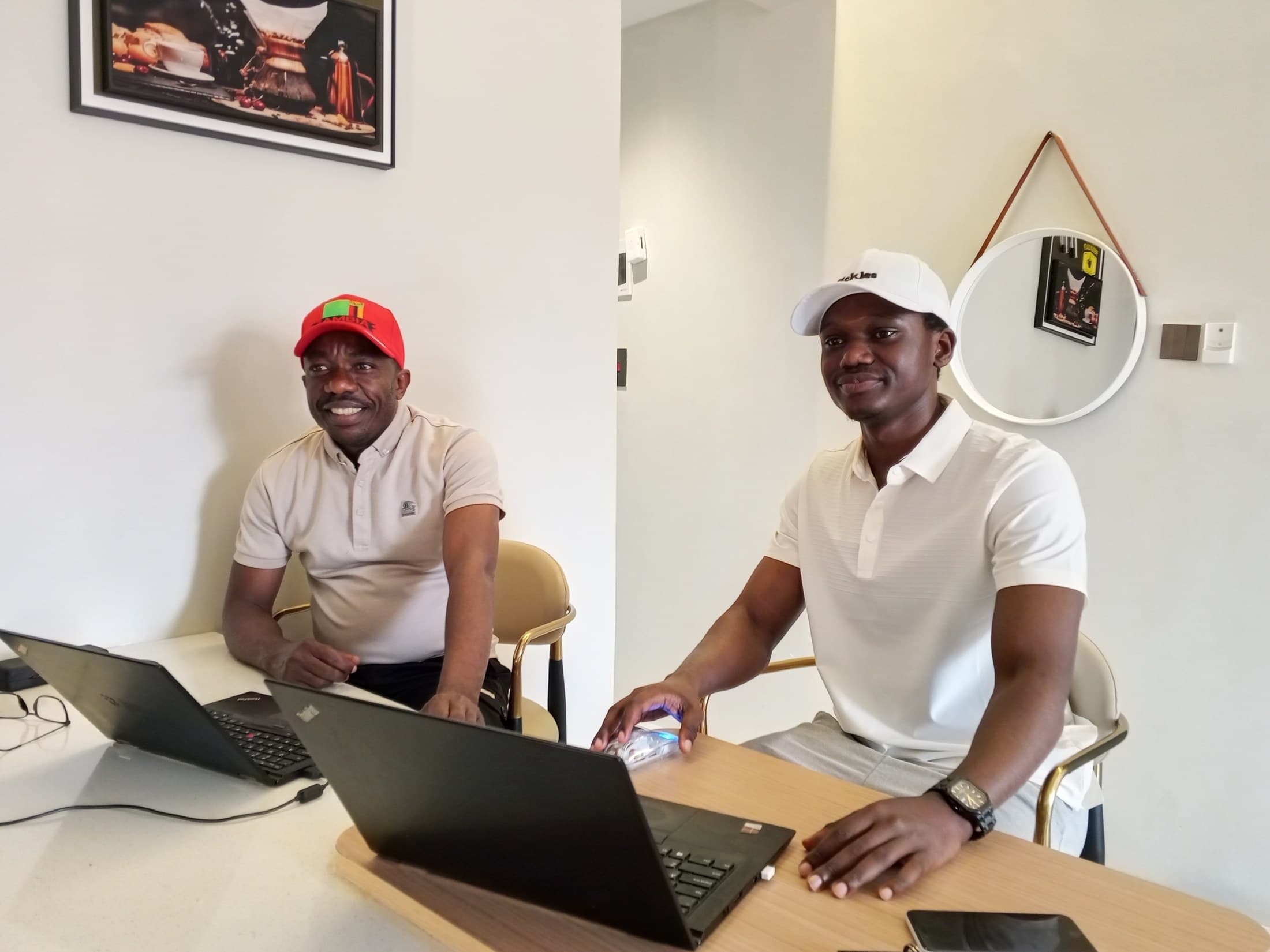 DJAFARI KILONGO Juvenal and Ian Abenaitwe during their discussion on AIDG's digital development